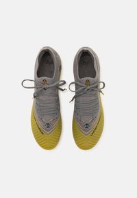 Under Armour SHADOW ELITE 2.0 FG - Scarpe da calcio per terreni duri - clay green/taxi/black