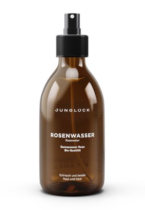 Brown glass bottle of rosewater with a black spray nozzle. Features white text detailing product name and ingredients. Cylindrical shape.