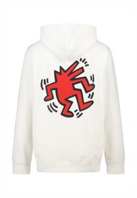 Sudadera blanca con un gran gráfico rojo de una figura estilizada en la parte posterior, contorneada en negro. Material suave con un corte relajado.