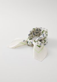 White silk scarf featuring colorful dinosaur patterns, with a light green geometric accent along the edges and pointed ends.