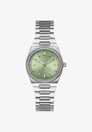 Silberner Metallarmbanduhr mit grünem Zifferblatt, roségoldenen Zeigern und Stundenmarkierungen. Verfügt über eine mit Kristallen besetzte Lünette und ein Gliederarmband-Design.