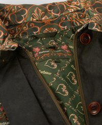Barbour jacket interior featuring a dark exterior, green floral lining with orange and pink accents, and brown buttons on the front.