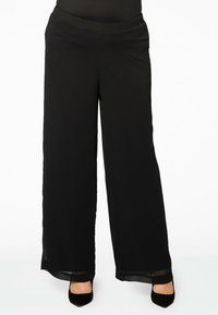 Zwarte wijde broek van lichtgewicht stof, met een gladde tailleband en doorschijnende accenten bij de zoom. Tailored ontwerp.