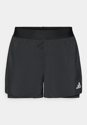 Black athletic shorts made of lightweight fabric, featuring a wide elastic waistband and a small white logo on the lower left side.