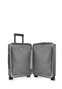 Valise rigide gris foncé avec une poignée rétractable. L'intérieur comporte des poches en maille et des doubles compartiments pour un rangement organisé.