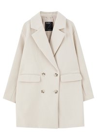 Cappotto beige doppiopetto con ampi revers, due tasche frontali e sei bottoni tondi. Realizzato in un tessuto morbido e testurizzato.