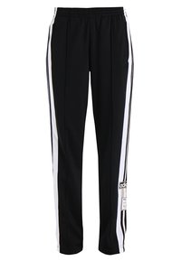 Svarta träningbyxor med vita sidostråk, elastisk midja, slät front och en logotyprem på nedre vänstra benet. Slät tygtextur.