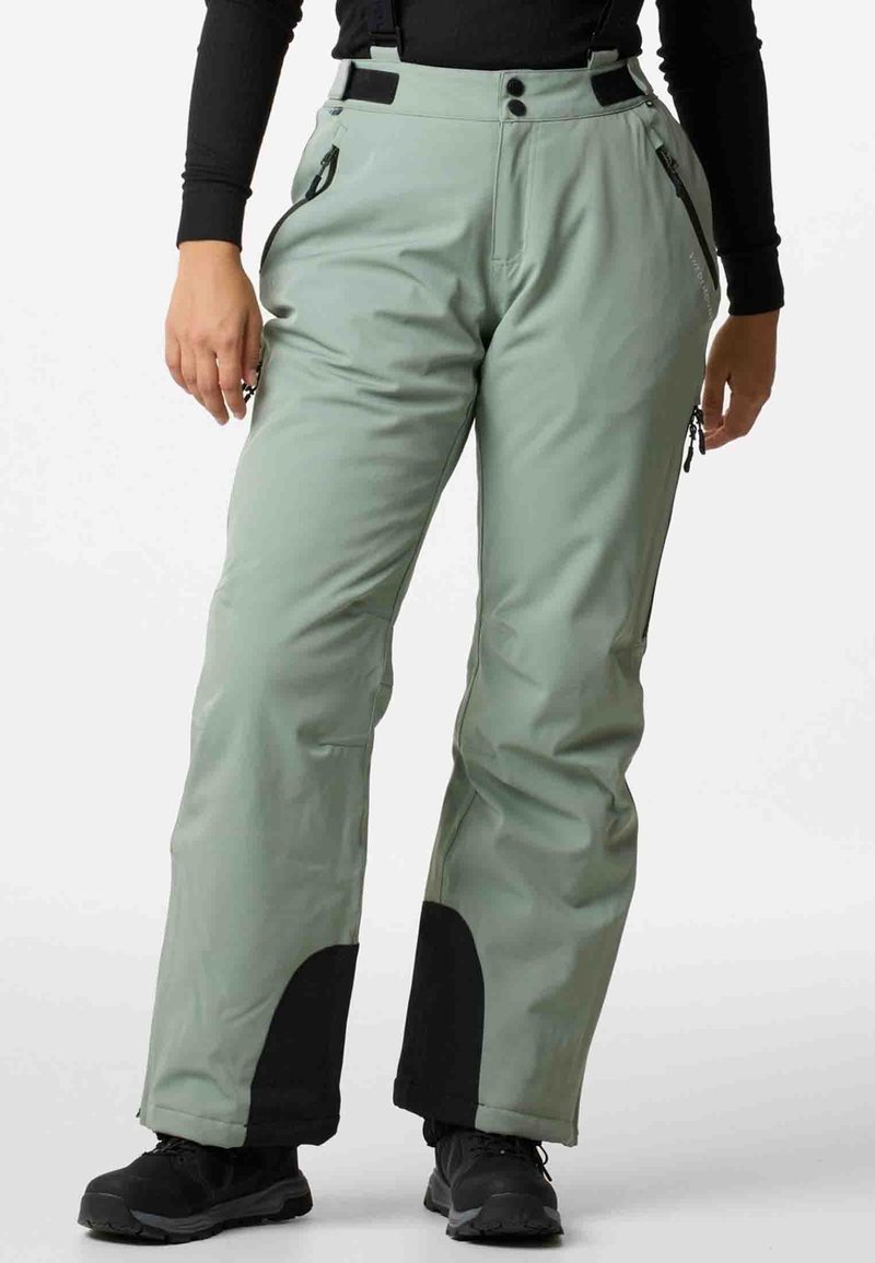 Light green snow pants with black reinforced ankles, adjustable straps, zippered pockets, and smooth, water-resistant fabric.