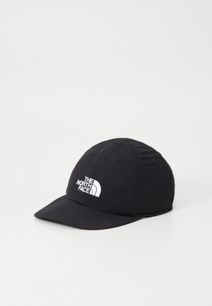 Black baseball cap made of fabric with a curved brim. Features embroidered white logo on the front and ventilation holes on top.