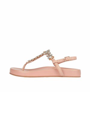 Sandali piatti rosa con design a T, adornati con accenti di gioielli trasparenti e una fibbia regolabile alla caviglia. Sole in gomma liscia.