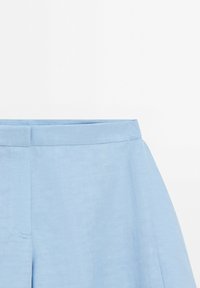Light blue high-waist trousers with a flat waistband and hidden front fastening, made of smooth fabric.