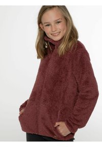 Giacca in fleece bordeaux con colletto alto, chiusura con zip, tasche laterali e una superficie morbida e testurizzata. Adatta per abbigliamento casual.