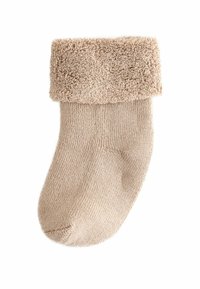 Beige Sock mit plüschigem, strukturiertem Bündchen. Gestrickter Körper mit feiner Rippung, glatter Oberfläche und runder Zehenpartie. Geeignet für die Freizeit.