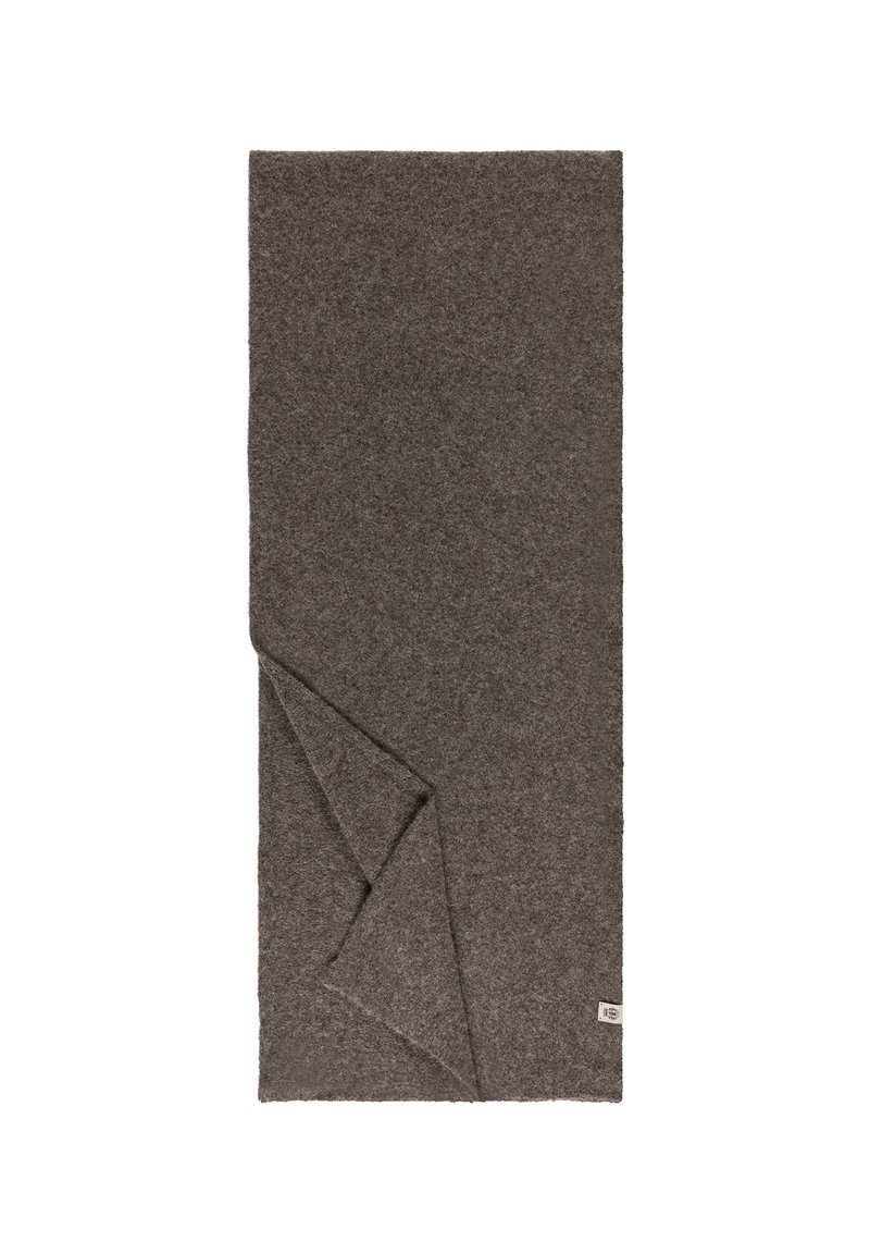 Graue Wolldecke mit einer weichen, strukturierten Oberfläche, an einer Ecke gefaltet, mit einem kleinen Etikett am Rand.