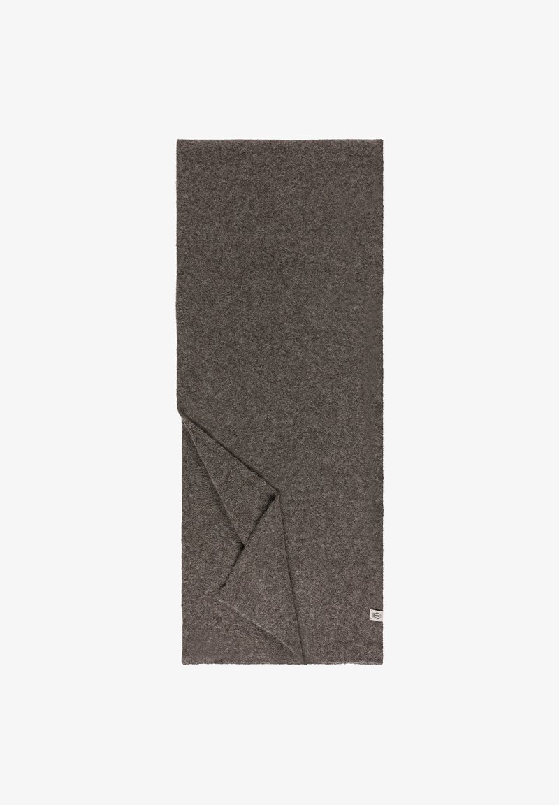 Graue Wolldecke mit einer weichen, strukturierten Oberfläche, an einer Ecke gefaltet, mit einem kleinen Etikett am Rand.