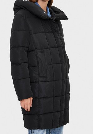 Black puffer coat with a large, quilted design and oversized hood. Features front pockets and a relaxed fit, made from smooth synthetic material.