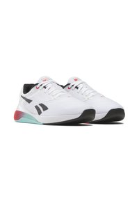 White athletic shoes with a textured mesh upper, black accents, red and teal detailing, and a black rubber sole. Features a lace-up design.