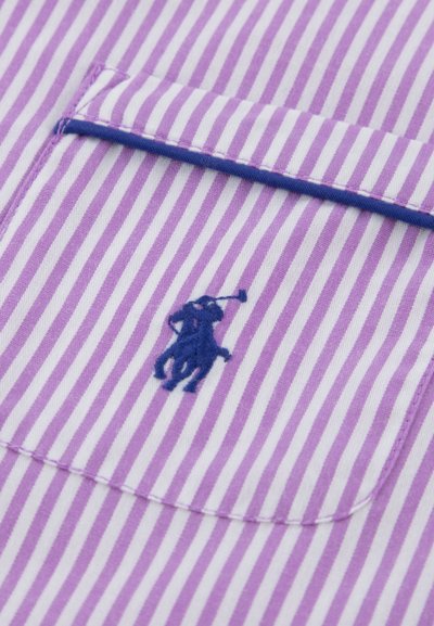 Lilla og hvide stribede stof med en brystlomme. Indeholder en blå broderet polospillerlogo på lommen. Glat tekstur.