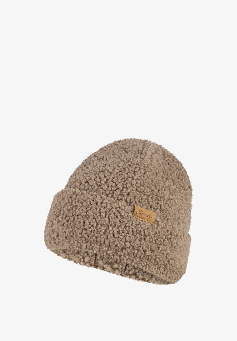 Beige textured fleece beanie with a small stitched fabric label on the folded cuff.