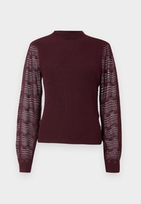 Bordo pulover s rebrastim tijelom i prozirnim, uzorkom pletivom rukavima; ima visok izrez i uske manšete.