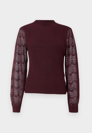 Pull bourgogne avec un corps côtelé et des manches en tricot translucide à motifs ; il présente un col haut et des poignets ajustés.