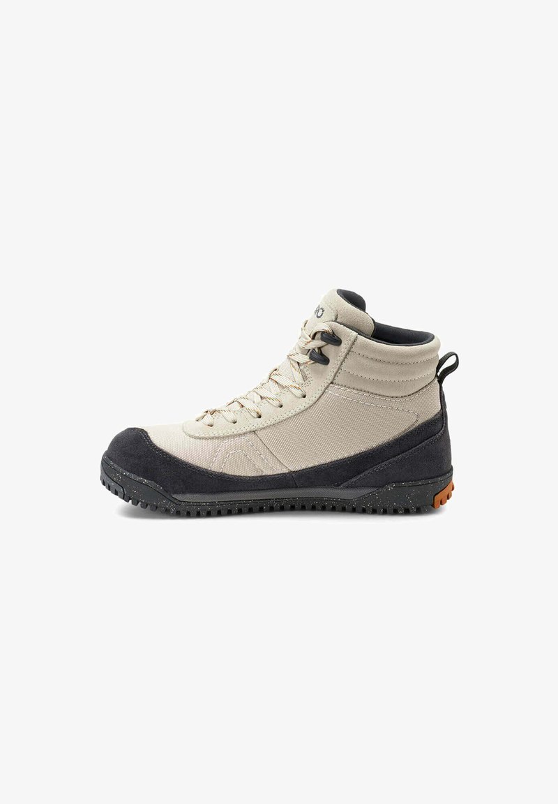 Botte d'extérieur montante beige et noire avec fermeture à lacets et semelle en caoutchouc texturé, conçue pour la randonnée ou une utilisation robuste.