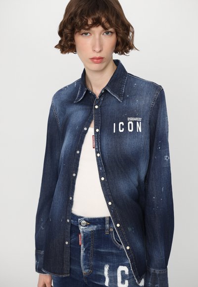 Tumedate pesu denim särk, millel on terav krae, ees tasku ja "ICON" logo. Omab kulumise detaile ja nupuvajutusega kujundust.