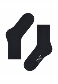Un paio di calzini alla caviglia blu scuro, uno mostra la suola con il marchio bianco "Falke Cozy Wool" e le informazioni sulla taglia.