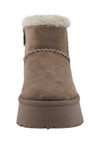 Brown suede winter boot with thick rubber sole, decorative stitching, and fluffy white fur trim around the ankle opening.