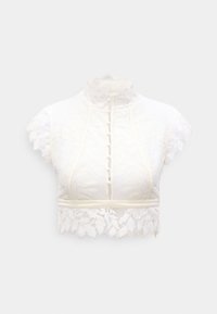 Δαντελένιο κοντό τοπ με ψηλό γιακά, κοντά καπάκια στα μανίκια και κλείσιμο με κουμπιά. Διαθέτει λουλουδάτα σχέδια και λεπτή κυματιστή τελείωμα σε εκρού.