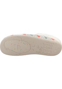 Suela de zapatilla blanca con goma texturada, con un colorido patrón floral y gráficos divertidos. Especias multicolores esparcidas por la superficie.