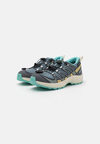 Grey hiking shoes with turquoise accents, mesh upper, black laces, and a reinforced toe cap, featuring a textured sole for traction.