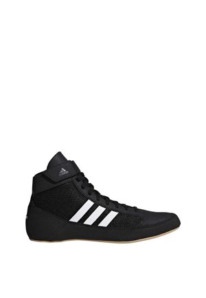 Chaussure de sport Adidas noire montante avec des bandes blanches et une semelle en gomme, conçue pour le maintien de la cheville et un usage sportif.