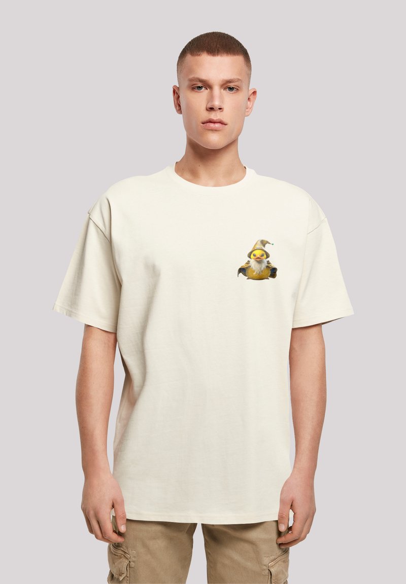 Cream cotton t-shirt with a relaxed fit, featuring a colorful cartoon print of a bird with a hat on the left chest area.
