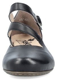 Chaussure de style Mary Jane noire en cuir, avec un bout arrondi, deux sangles croisées et une semelle intérieure rembourrée. Surface texturée avec une semelle plate.