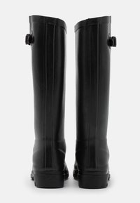 Black waterproof rubber boots with a smooth texture, tall shaft, and a buckle detail on the side for adjustable fit. Flat soles.