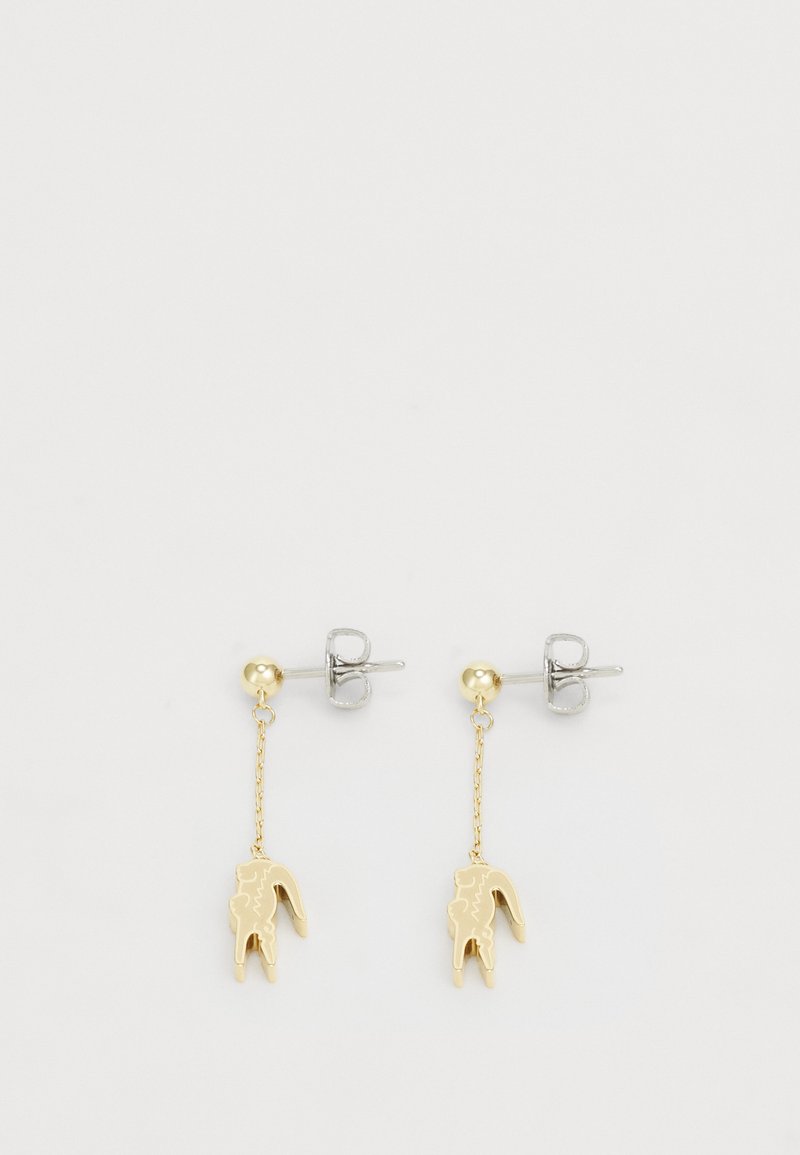 Gold-tone dangle earrings featuring a tooth-shaped charm, connected by a fine chain, with a silver-tone stud backing.