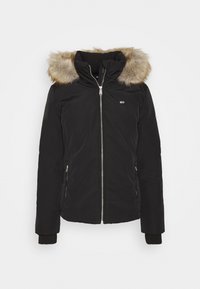 Parka noire avec capuche en fausse fourrure, fermeture éclair à l'avant et poches latérales. Poignets côtelés et détail logo sur la poitrine. Texture lisse.