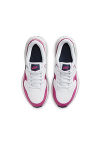 Nike-Sneaker mit einem weißen Netzoberteil und pinken Akzenten, navyblauem Innenraum, weißen Schnürsenkeln und einer schwarzen Sohle. Rundliche Zehenform.