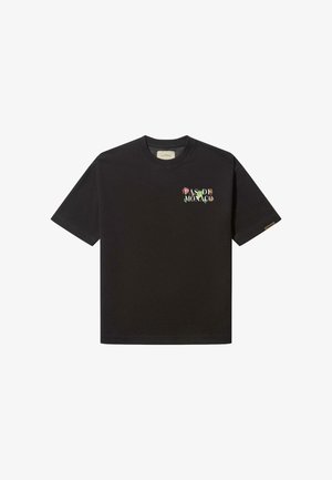 Schwarzes Baumwoll-T-Shirt mit kurzen Ärmeln, geripptem Rundhalsausschnitt und besticktem "PAS DE MONACO" in bunten Blumenbuchstaben auf der Brust.