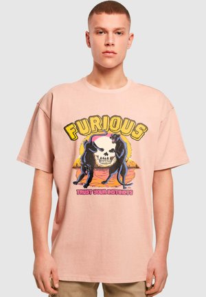 Pink cotton t-shirt featuring a graphic design of two black panthers, a skull, and the text "FURIOUS" and "TRUST YOUR INSTINCTS."