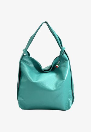 Teal leather handbag with a slouchy design, curved top opening, short handles, and a small Italian flag charm attached.