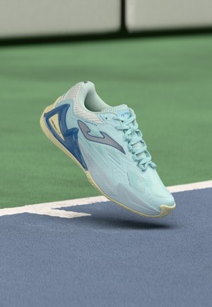 Light blue athletic shoe with a textured upper, contrasting blue accents, and a yellowish sole, designed for performance on a court surface.