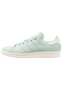 Sneaker in pelle verde chiaro con dettagli bianchi, punta tonda, sei fori per i lacci e dettagli perforati sui lati. Suola in gomma con logo.