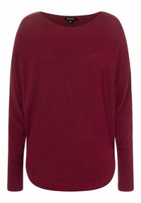 Pull en maille bordeaux avec un large col, des manches longues et une coupe décontractée. La texture est lisse avec un motif subtil. Ourlet arrondi en bas.