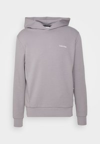 Sudadera gris claro de Calvin Klein con mangas largas, capucha y pequeño logo blanco en el lado izquierdo del pecho, presentada sobre un fondo blanco liso.