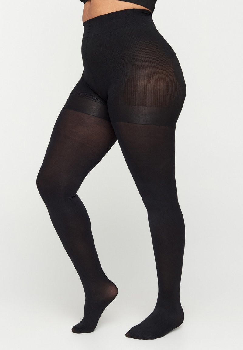 Svarta strukturerade strumpbyxor med randig midjeband, hög midja och genomskinlig del på nederdelen av benet. Slät yta och ogenomskinligt tyg genomgående.