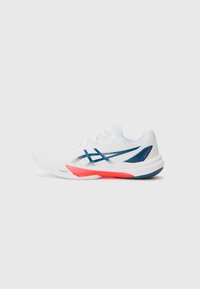 White athletic shoe with a textured upper, featuring a blue accent logo and red sole detail. Lightweight design for performance.