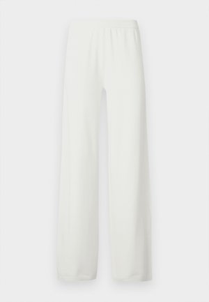 Valged laiad püksid, valmistatud pehmest, kergest kangast. Omavad elastset vöökohalt ja sirge lõikega säärtega. Ilma nähtavate mustrite või aktsentideta.