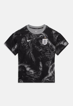 Maillot de football noir à manches courtes avec col gris, motif abstrait de loup, logo Nike sur la poitrine droite et écusson de l'équipe nationale d'Angleterre sur la poitrine gauche.